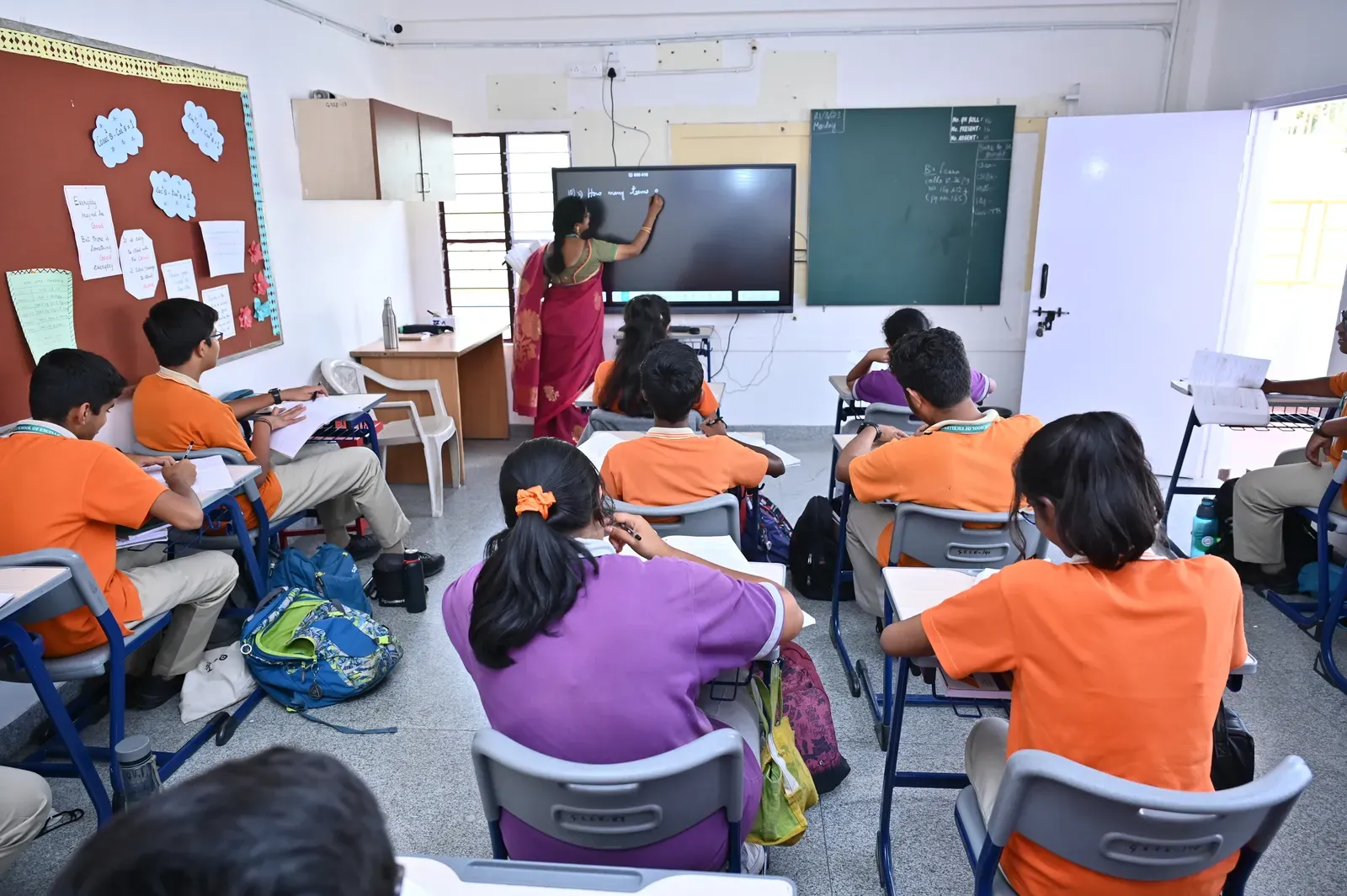 A classroom at Gnan Srishti with students at a digital board