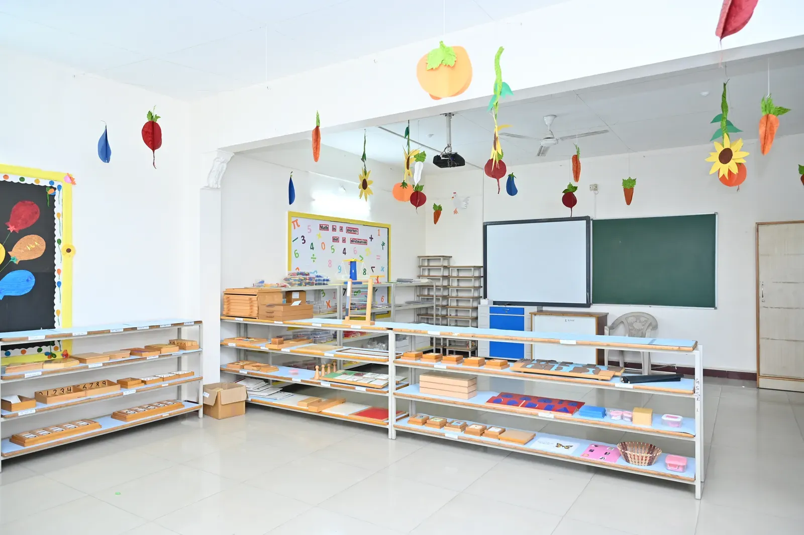 The activity room decorated with learning charts and Montessori shelves