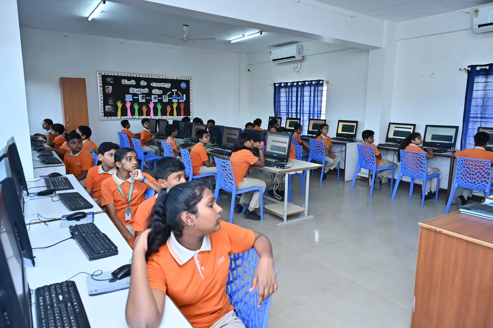 Students working at the computers in the school computer lab