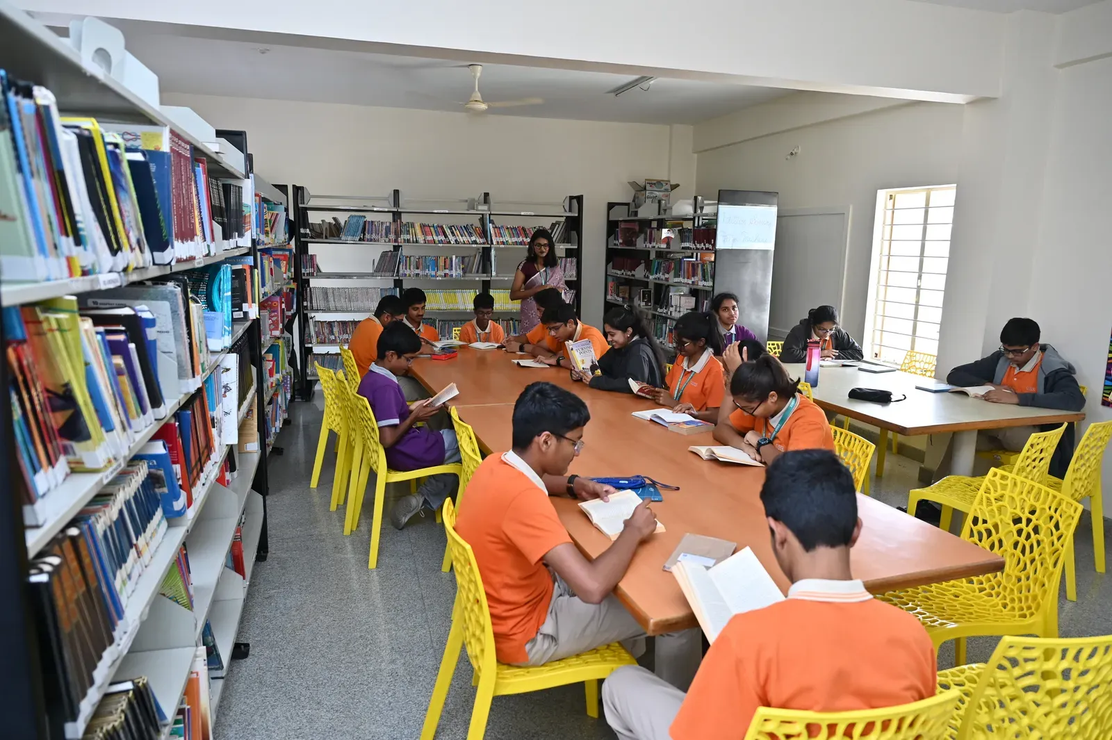 Bookshelves and a reading table in the school library