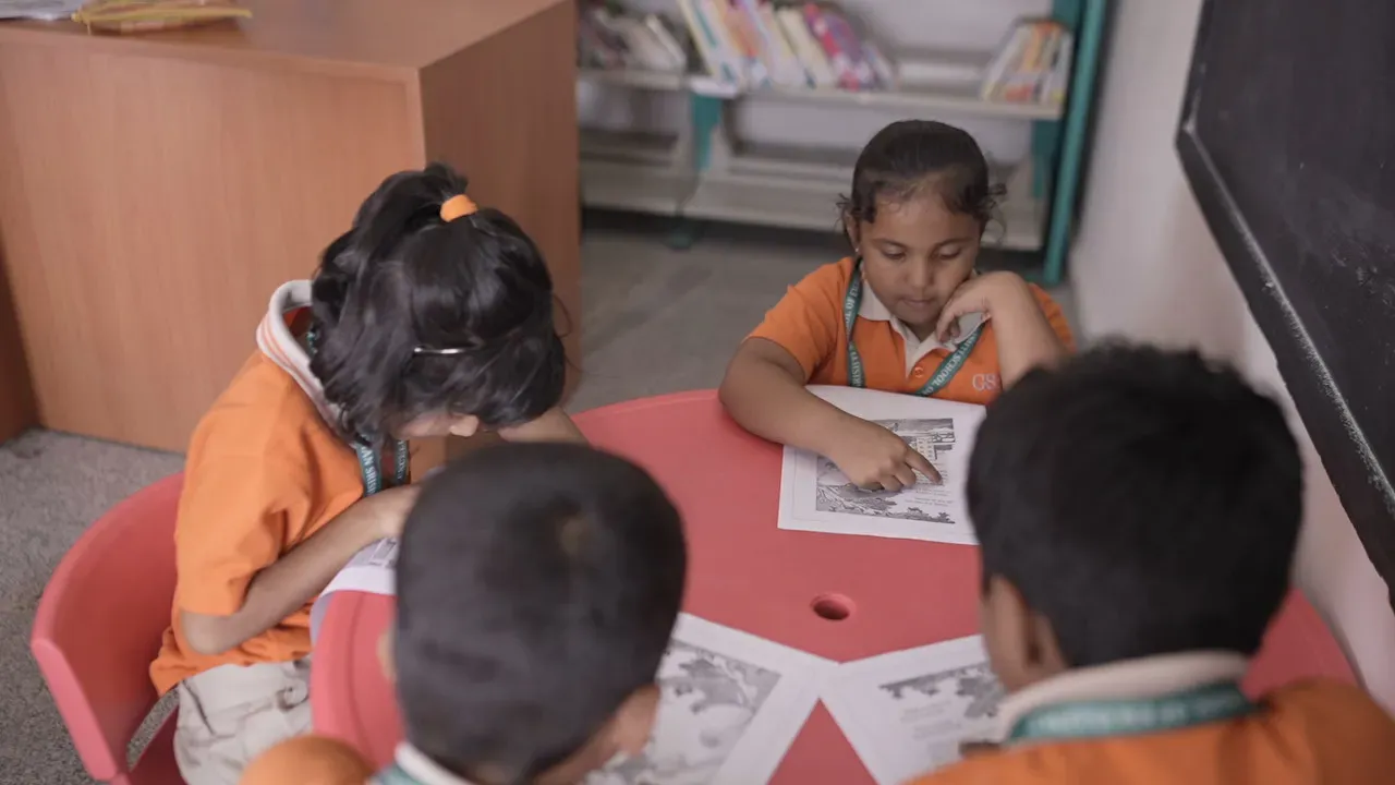Students seated at a table in the school library