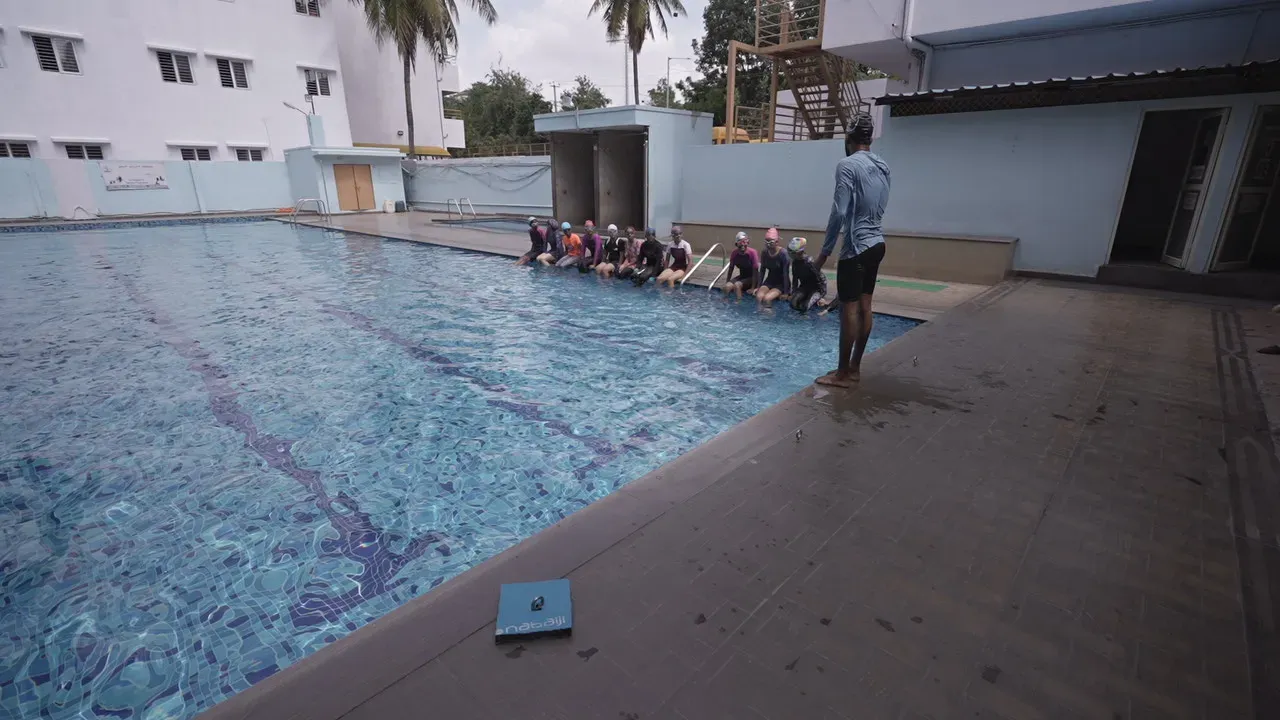 Students at a swimming session by the school pool