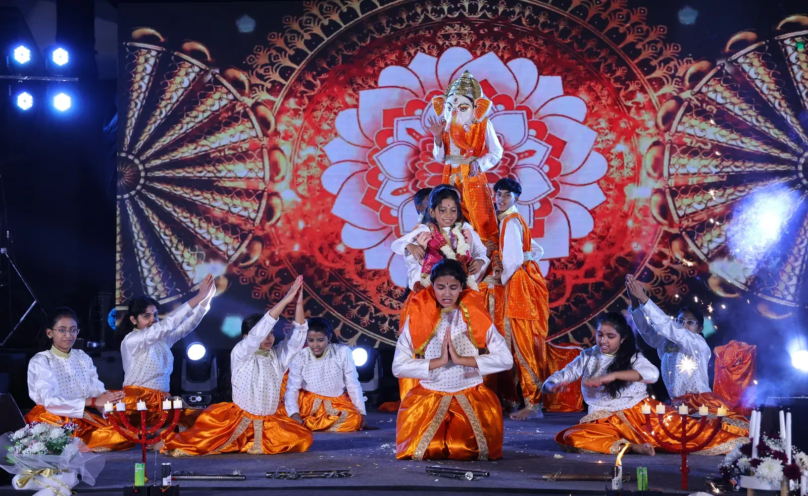 Students performing a classical dance on stage
